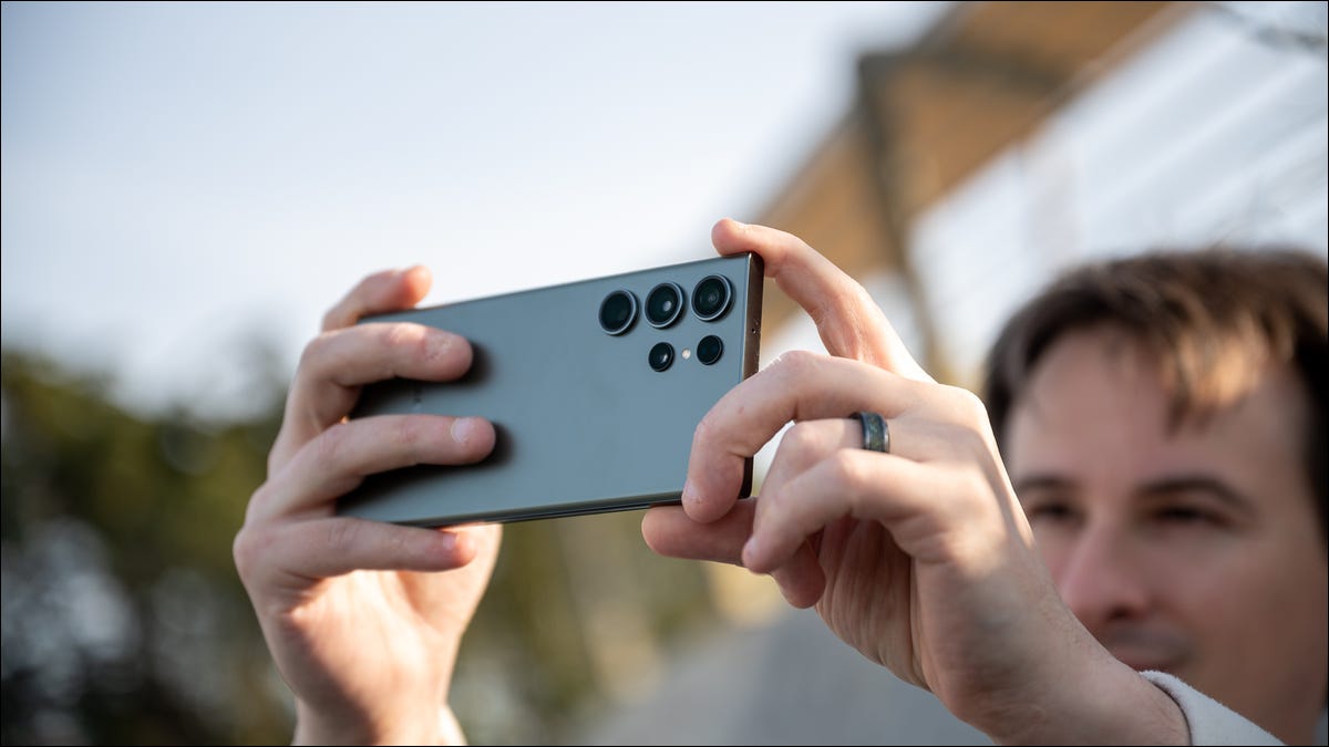 person-holding-the-samsung-galaxy-s23-ultra-in-green-and-taking-a-picture-1 person-holding-the-samsung-galaxy-s23-ultra-in-green-and-taking-a-picture-1