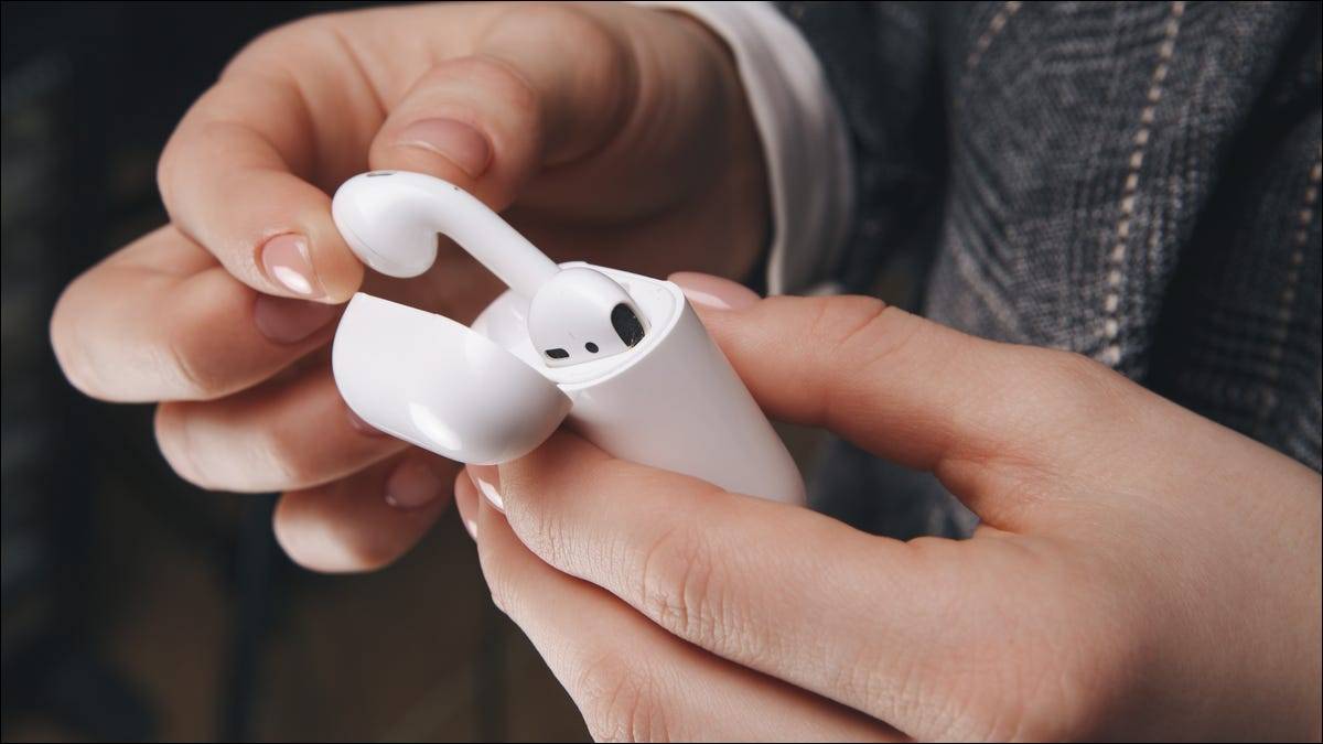 person-pulling-airpods-out-of-their-case person-pulling-airpods-out-of-their-case